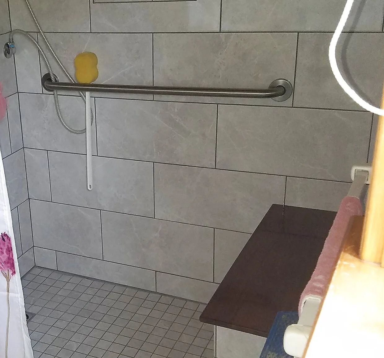 Custom tile walk-in shower with grab bar and built-in bench, accessible bathroom remodel, Upper Valley NH