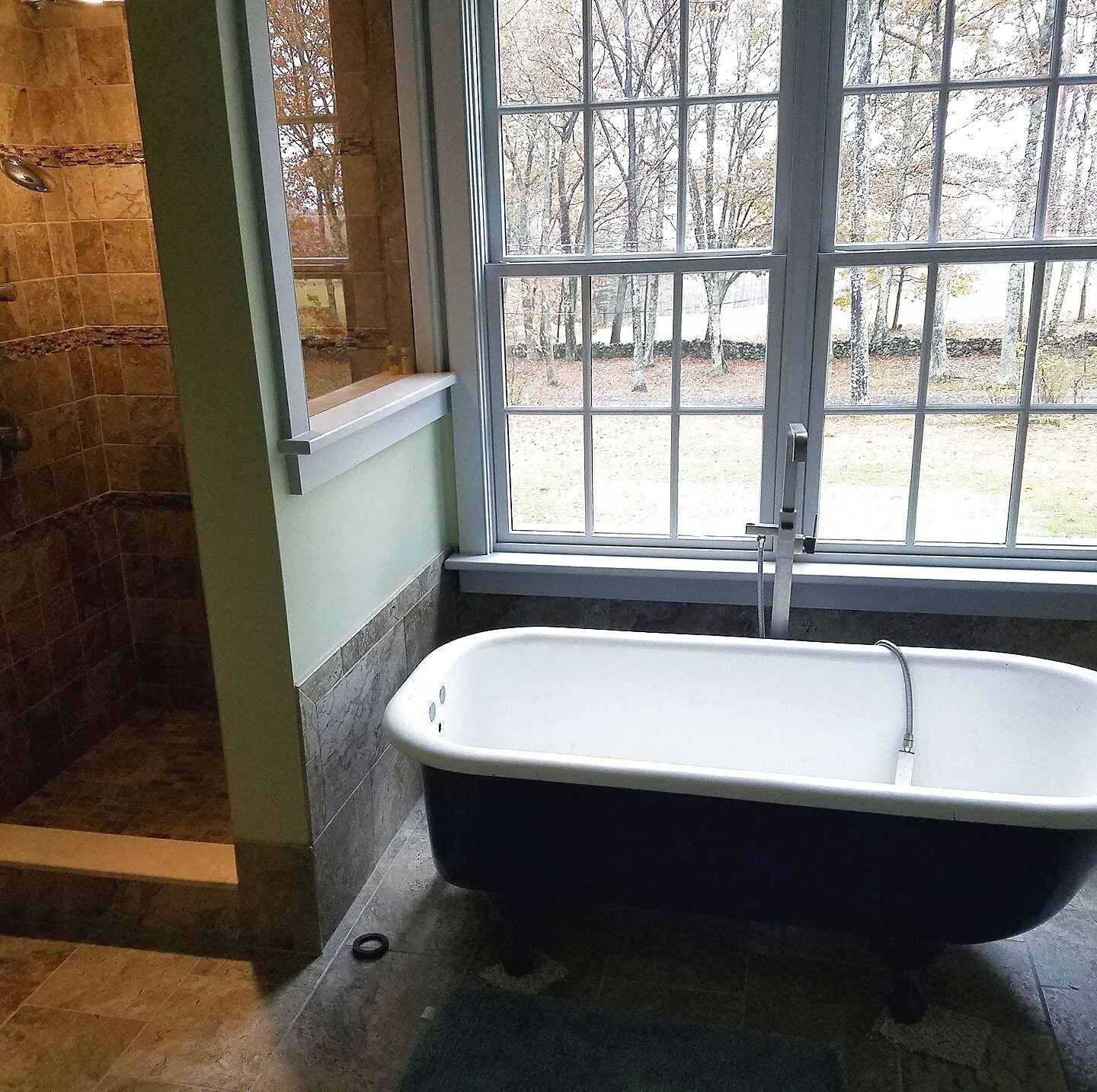 Bathroom remodel with a freestanding clawfoot tub and tile walk-in shower beneath a large window, Upper Valley NH